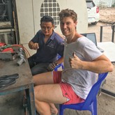 Image of 2 men in a workshop smiling at the camera